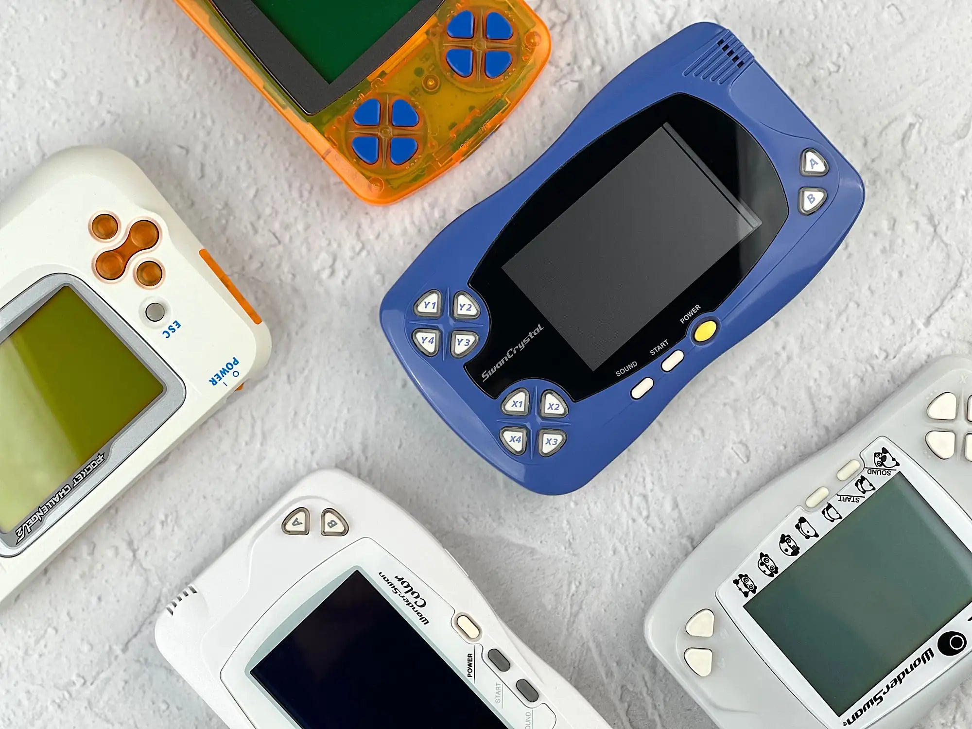 Multiple Wonderswan including Bandai Wonderswan Crystal in display for retro gaming players and collectors on RetroPixl