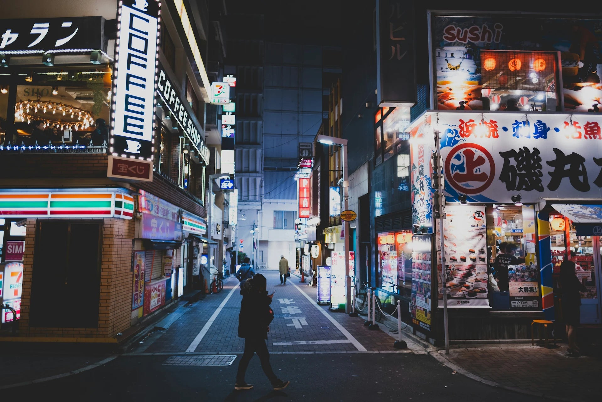 Japanese side street at night, symbolizing RetroPixl’s connection to authentic retro gaming and collectibles from Japan.