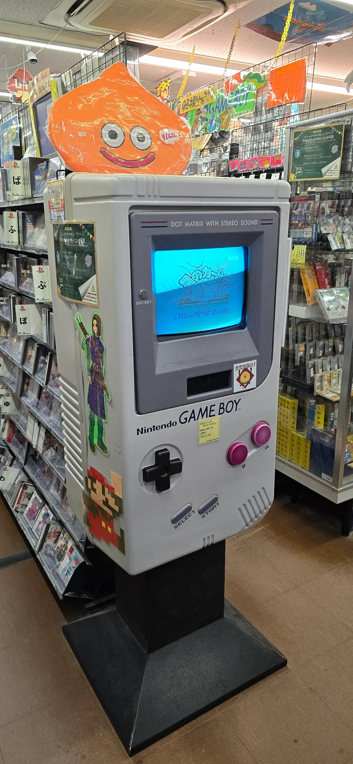 Giant Nintendo Game Boy display inside a Japanese retro game shop, reflecting RetroPixl’s Find It For Me service for rare consoles and collectibles.