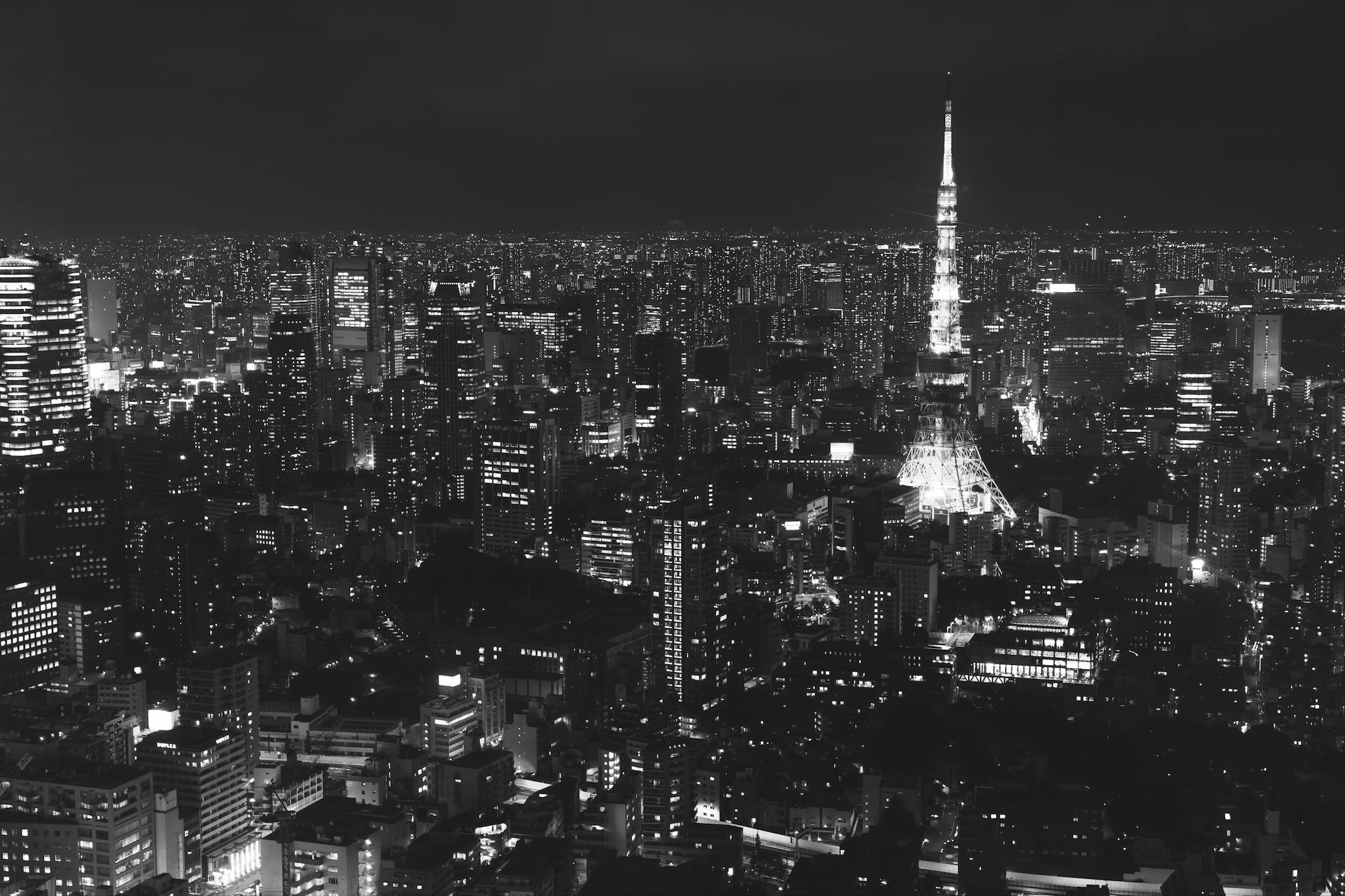 Black and white Tokyo skyline at night with Tokyo Tower, symbolizing RetroPixl’s past retro gaming drops and exclusive history.